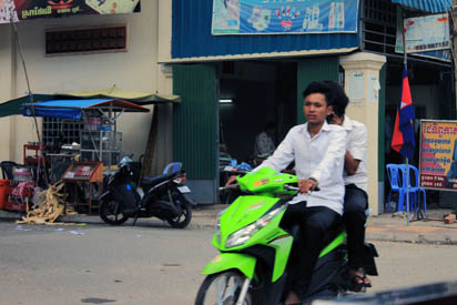 Cambodian with lime green scooter